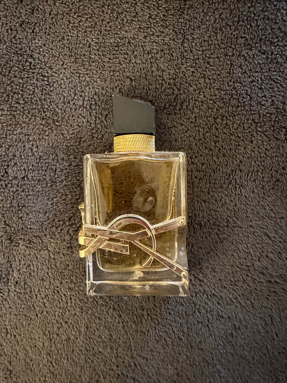 Yves Saint Laurent Clear Glass Perfume Bottle with Gold Logo and Black Cap